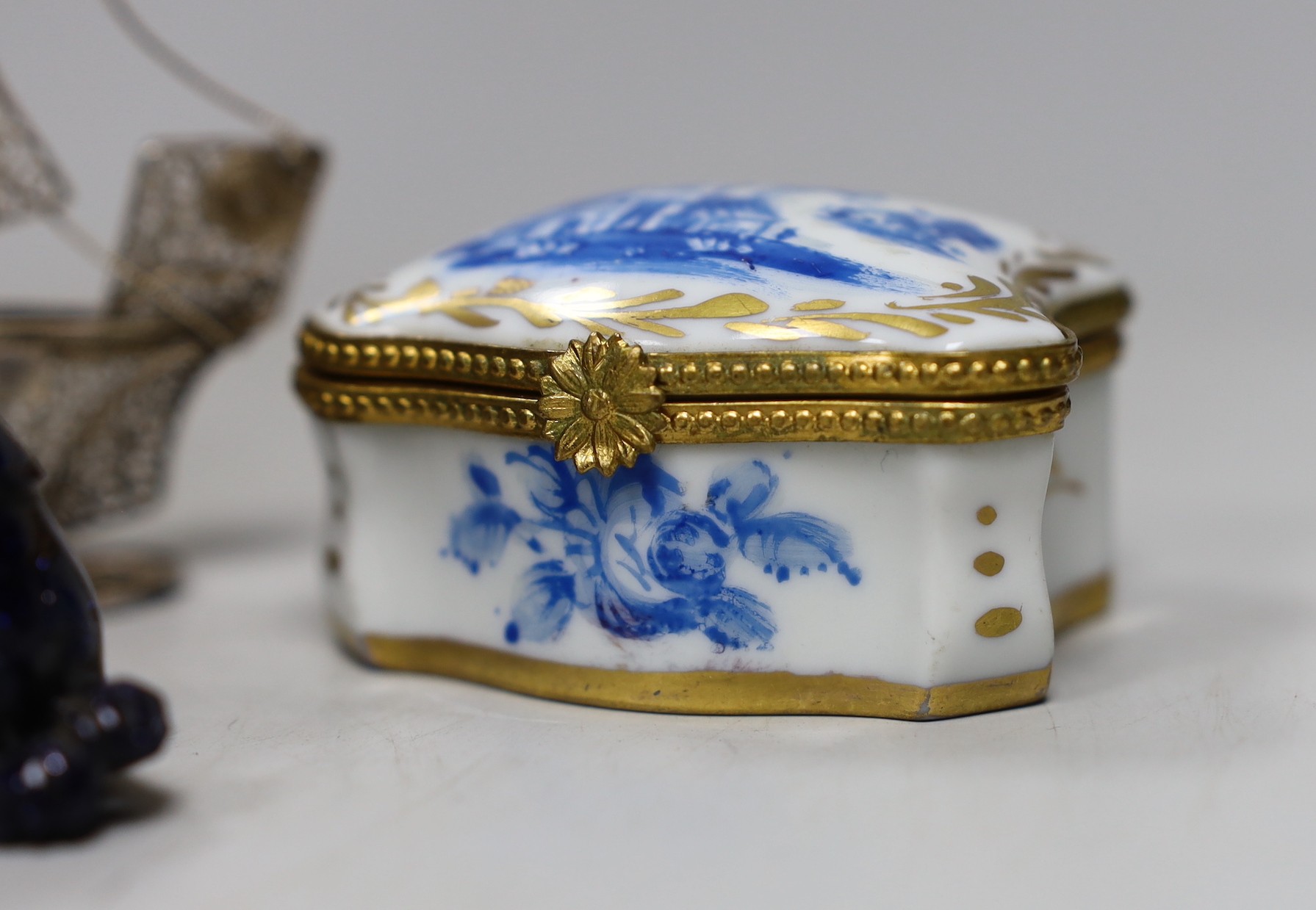 A silver mounted hinged folding wallet, 7.5 x 12cm, together with a filigree ship, a gilt and blue Limoges box and two animal figures